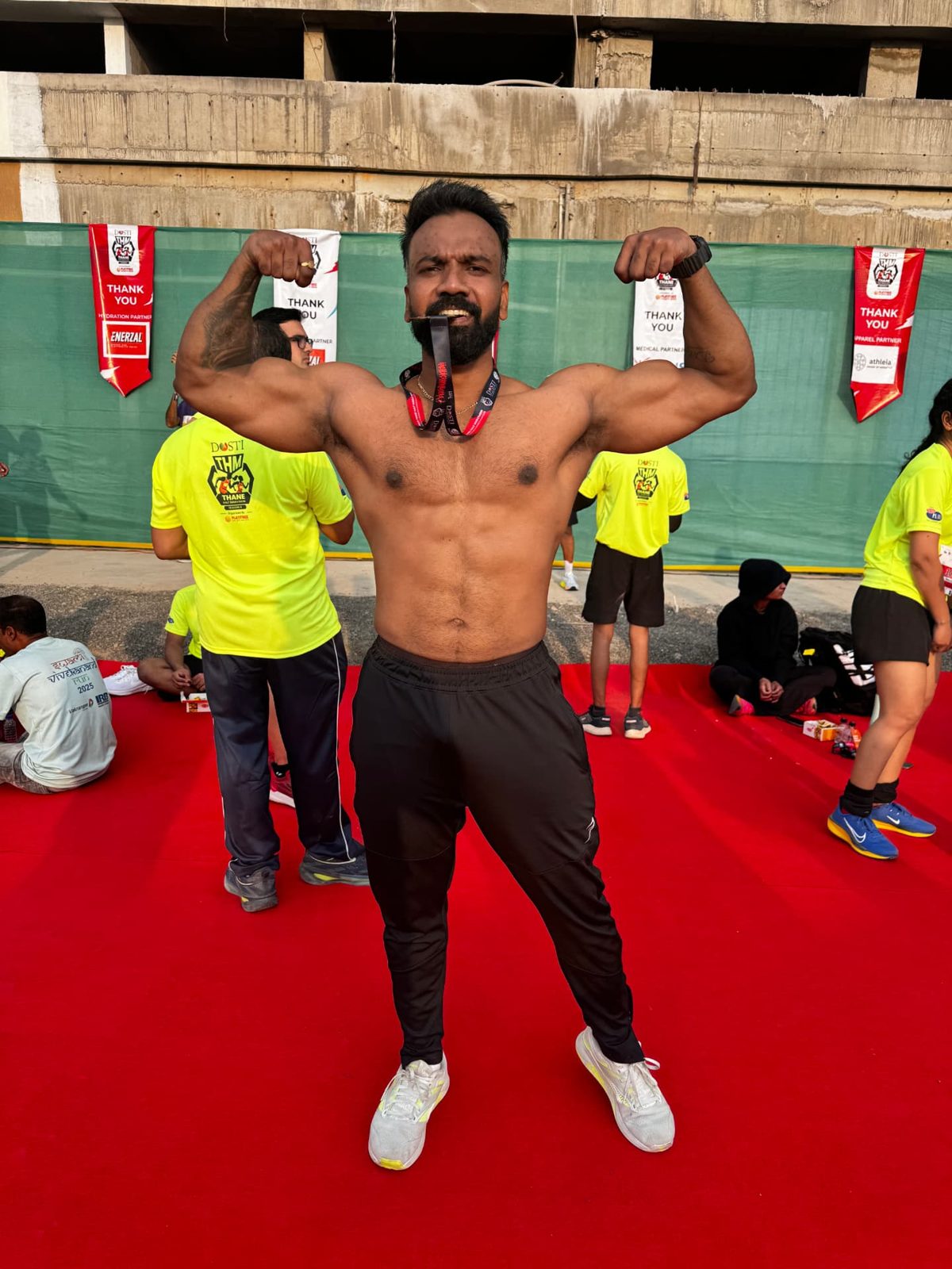 Mohit Mehral flexing after a half marathon finish